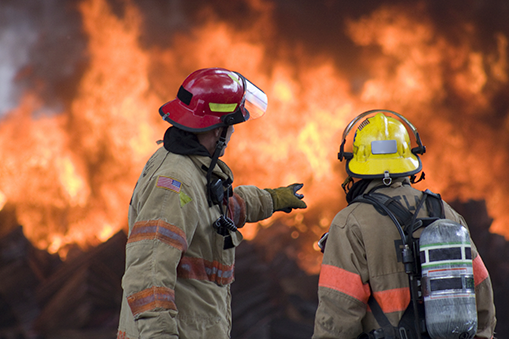 Two fire fighters assessing a scene. 